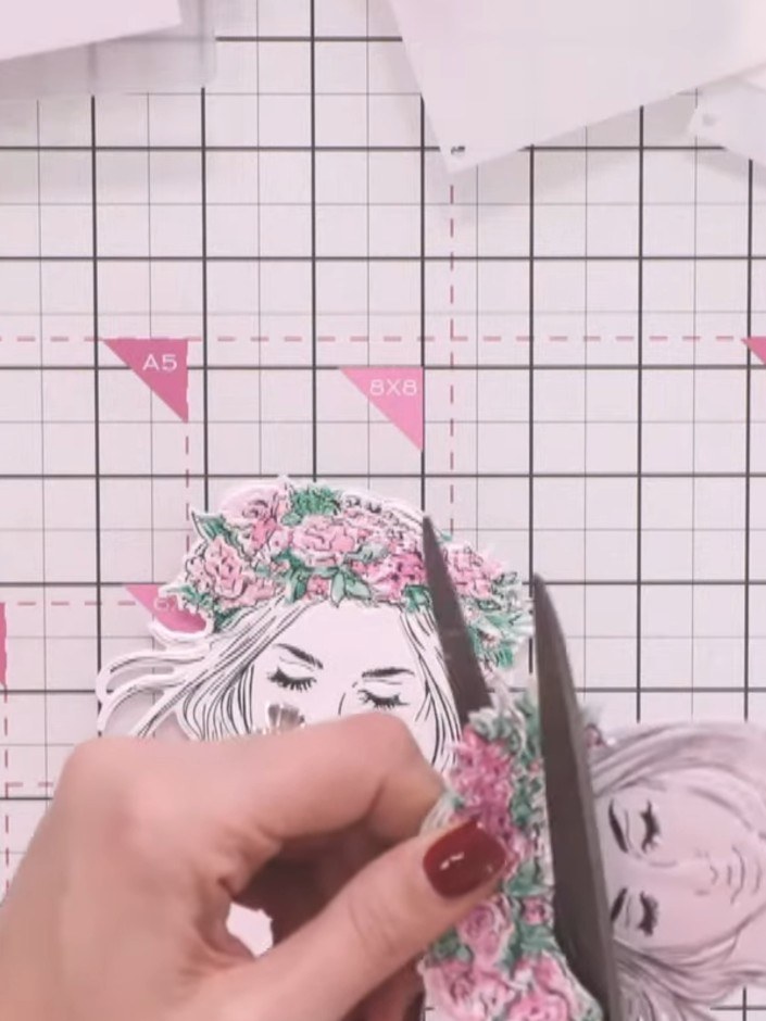 Step 8: Carefully cut around the hair piece shape from one of the embossed die cuts using scissors, following the outl