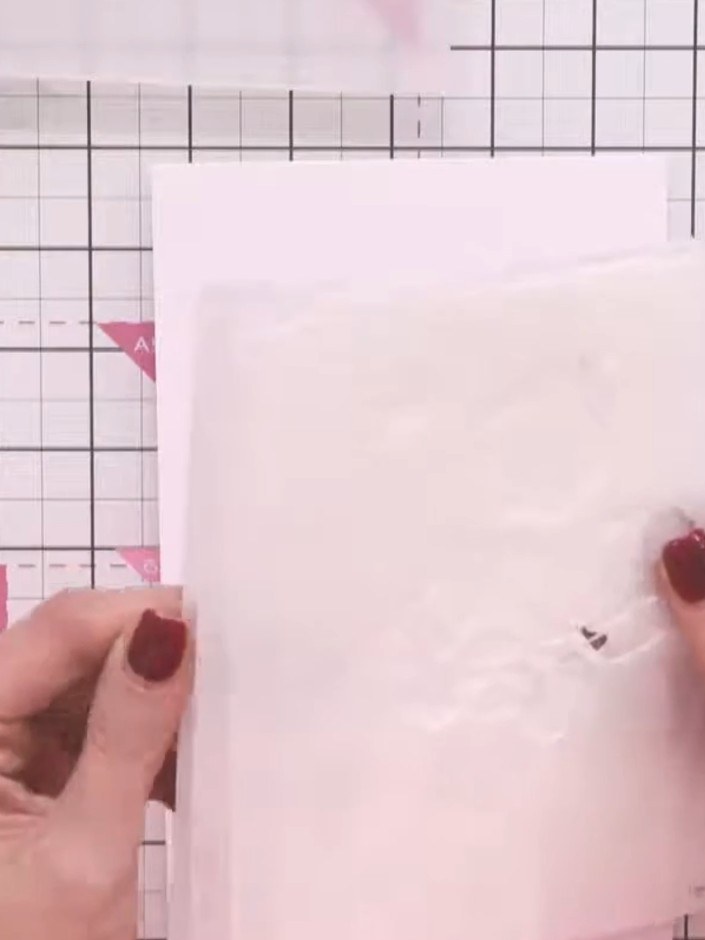 Step 1: Position the first layering stencil (numbered 1) on your white card base by aligning the four corner hearts wi