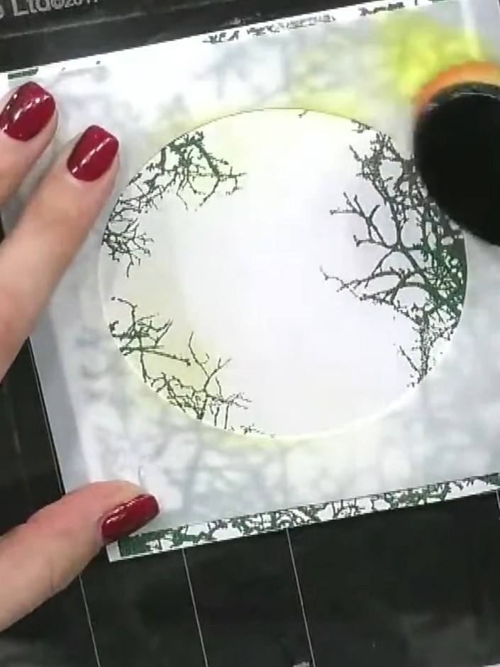 Step 6: Add orange ink to the blending brush, tapping off excess ink first. Blend the orange into the yellow area of t