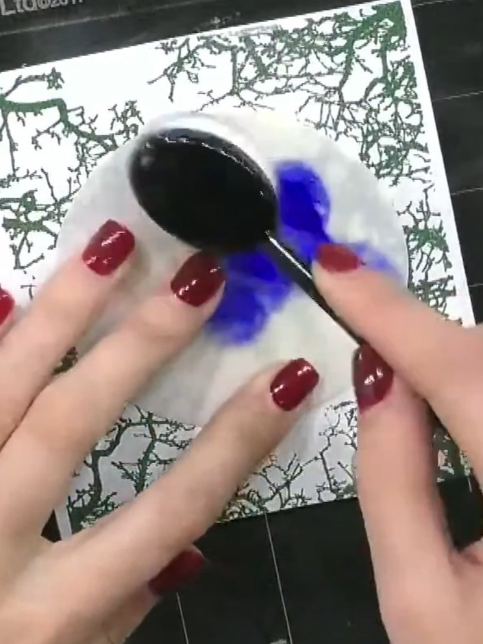 Step 8: Using a blending brush, drag blue ink from the stencil slowly across the card to create a sky effect, carefull