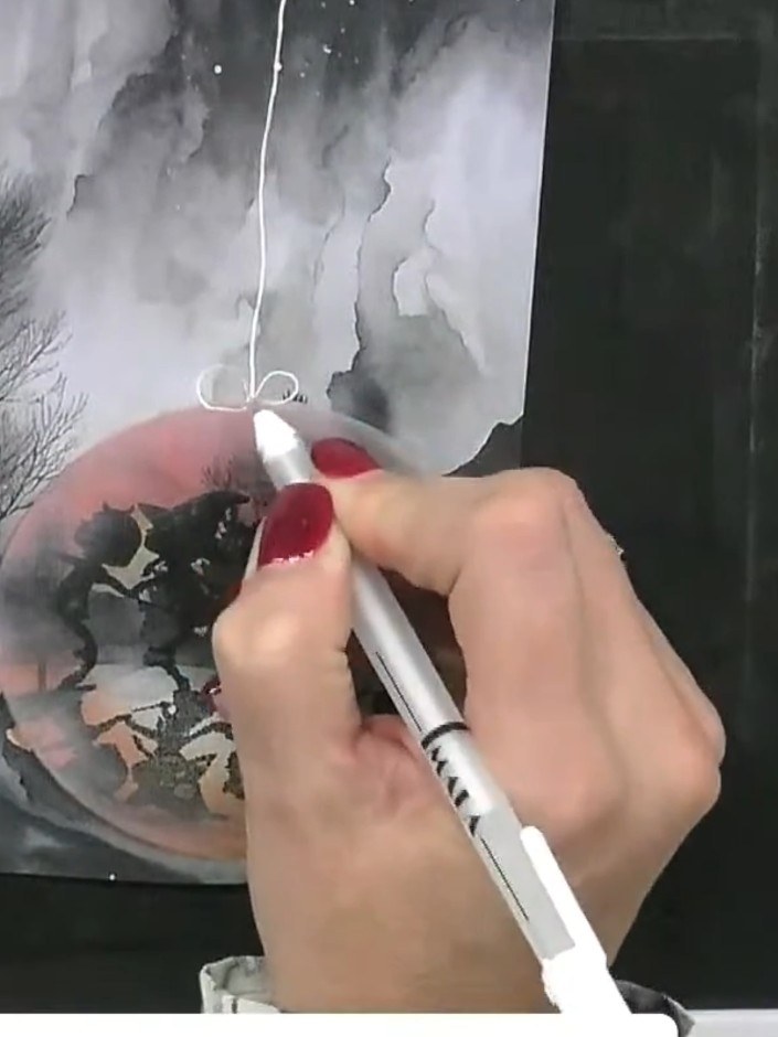 Step 6: Using a white ink pen, draw curved lines around the moon circle to create bubble reflections or a glass sphere