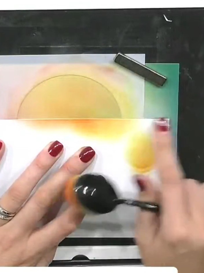 Step 3: Blend orange ink into the yellow area using a blending tool, working from the stencil edge outwards onto the p