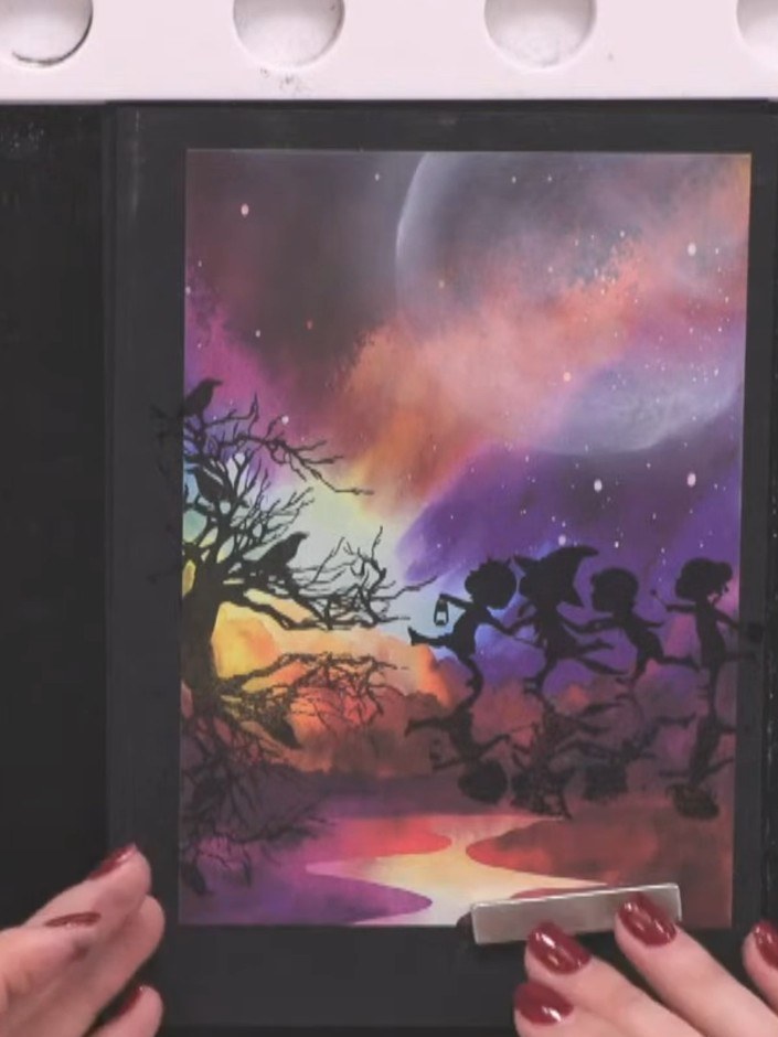 Step 5: Position and stamp a sentiment such as 'Trick or Treat' below the reflection children silhouettes on your card
