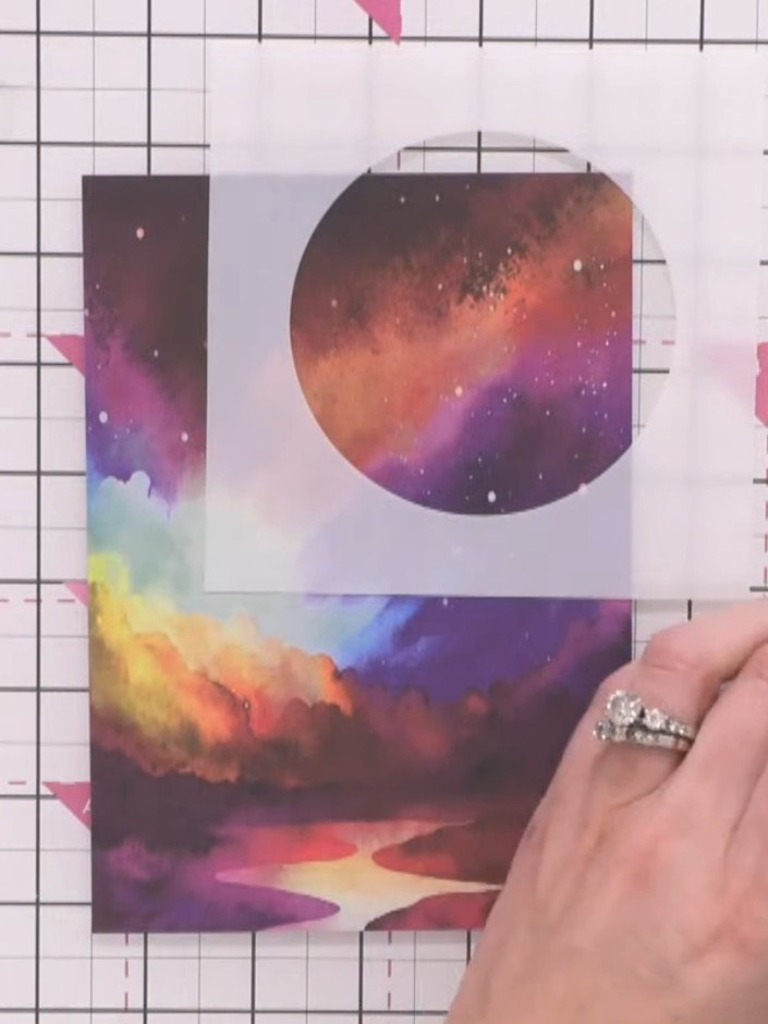 Step 1: Position the moon stencil on your galaxy card background near the top of the card. The circular moon shape sho