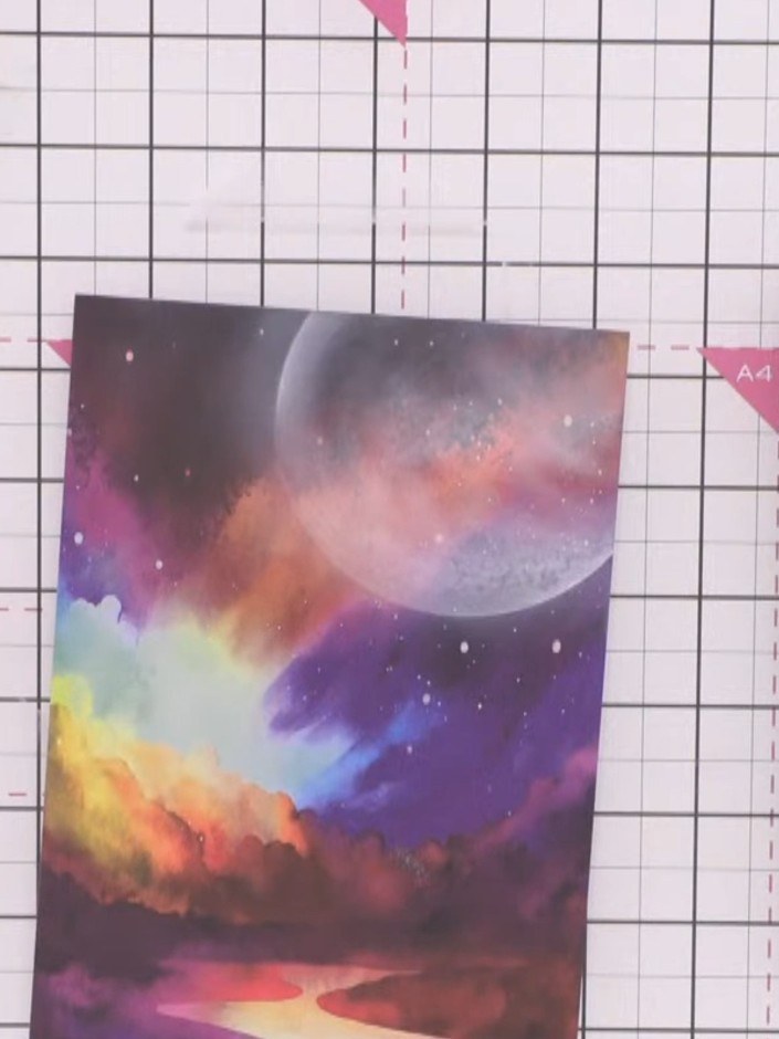 Step 8: Carefully lift the moon stencil away from the card to reveal your moon design with a soft halo effect around i