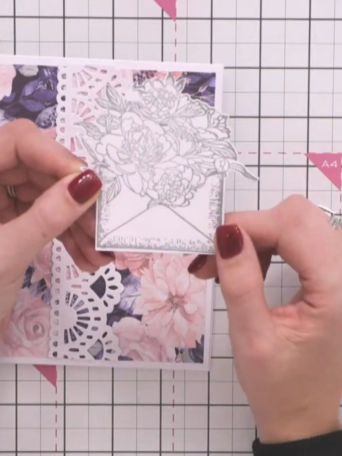 Step 2: Position the decorative lace border down one side of your floral card base, placing it slightly off-centre. Ad