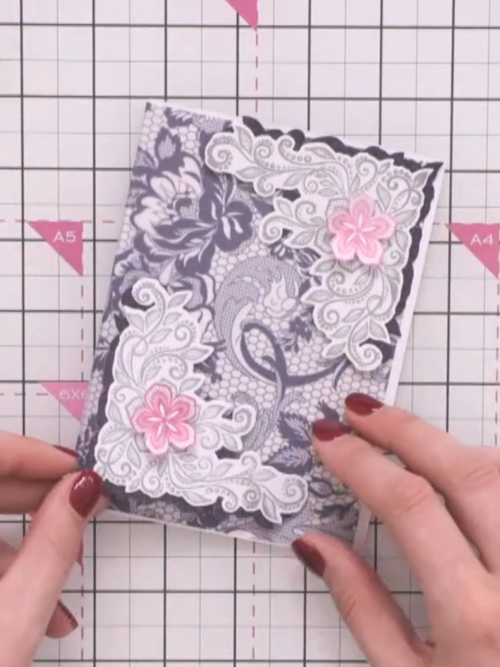 Step 6: Add small pink flowers to the lace elements to coordinate with the Midnight Blooms collection. Adhere the deco