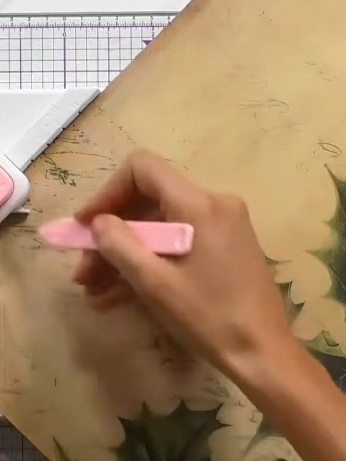 Step 3: Use the pink punch tool attached to the board to score along all the marked lines on the decorative paper. Wor