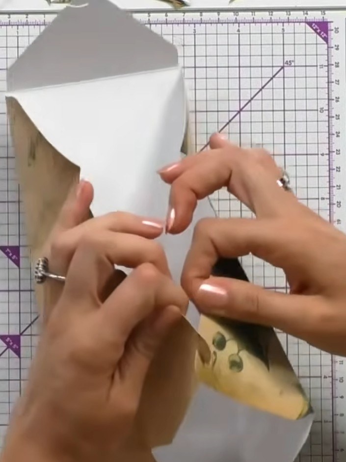 Step 8: Pinch the box together along the scored lines. Secure the hook-and-eye connectors by pressing them firmly into