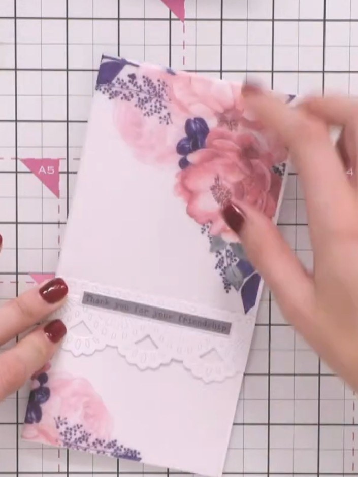 Step 6: Position the vellum sentiment piece centrally from side to side on the card front, placing it over the floral 