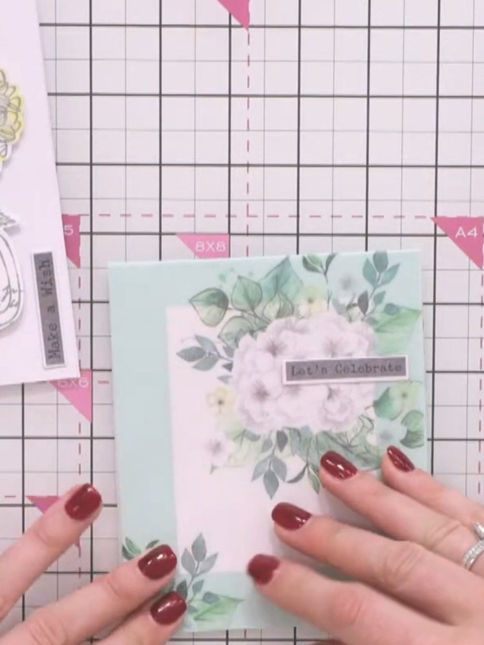 Step 4: Stamp the sentiment 'Let's Celebrate' onto the vellum panel at the top of the floral bouquet. Position the sen