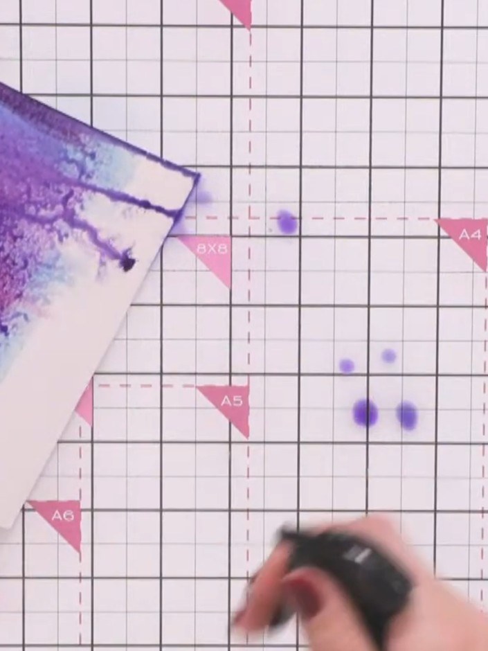 Step 6: Flick water onto your fingers and sprinkle it onto the dried background panel to create a mottled, starry text
