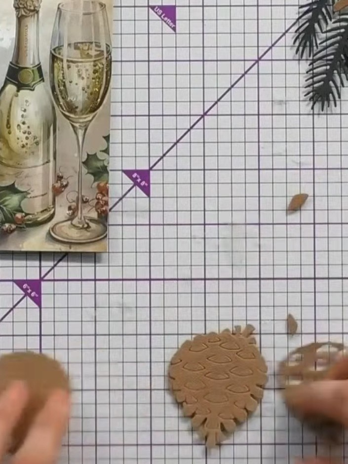 Step 2: Separate the base layer from your die-cut pieces. This layer features embossed detail and will form the founda