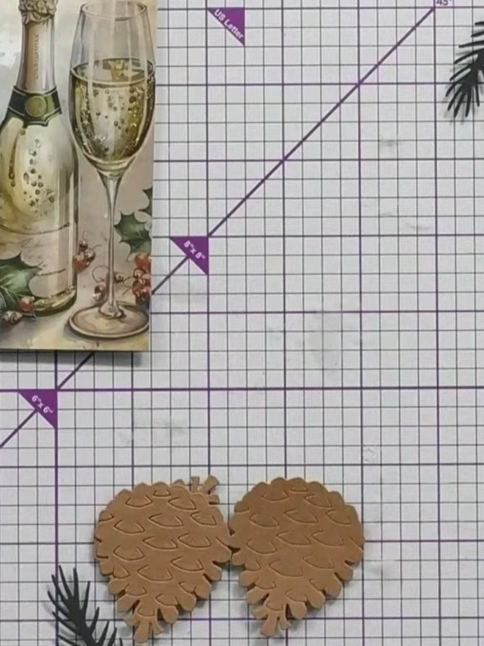 Step 3: Arrange the main pine cone layer pieces on your work surface. These kraft-coloured die-cut pieces feature indi