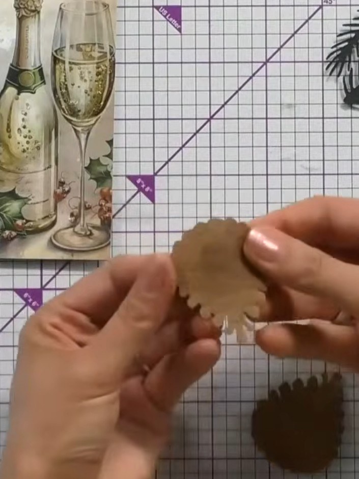 Step 5: Glue the main pine cone layer on top of the base layer, ensuring the embossed detail is visible underneath. Po