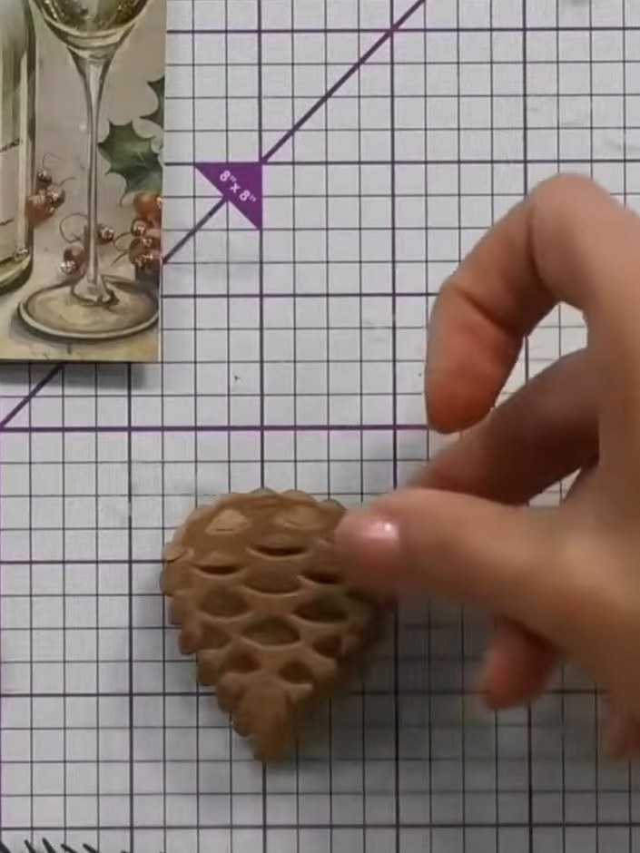 Step 7: Use a pokey tool to lift and bend each individual scale of the pine cone upwards, creating a three-dimensional