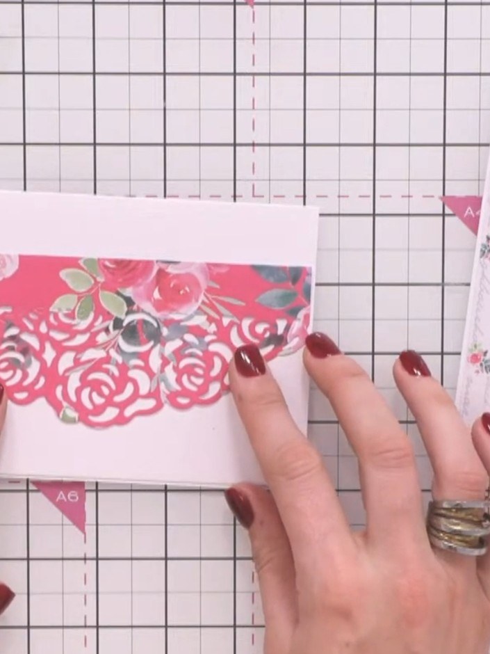 Step 1: Cut a strip of patterned paper from the collection. Position it across your white card base as a banner elemen