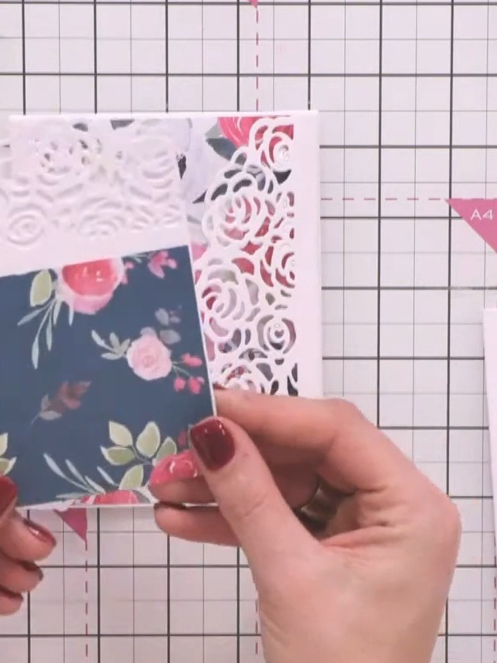 Step 1: Empieza con una tarjeta tipo nota con doblez superior como base. Position a white rose-patterned die-cut panel on top, then la