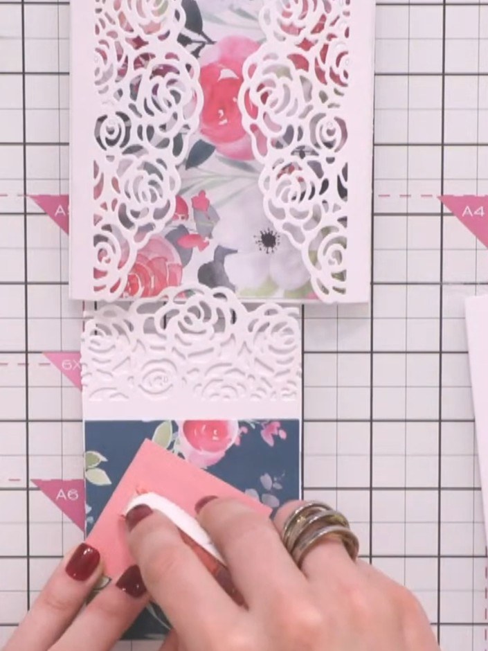 Step 3: Cut a small strip from the edge of the navy blue floral patterned paper panel to create a bookmark. Use the pi