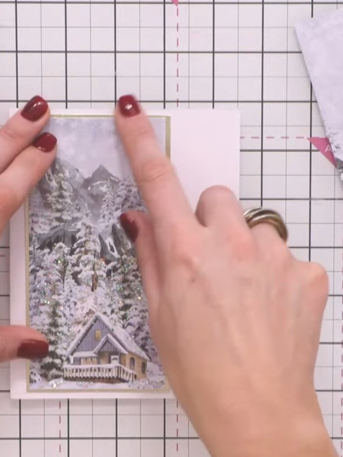 Step 4: Secure the winter scene panel to your card base using adhesive tape, positioning it centrally on the front of 