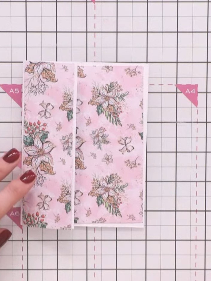 Step 2: Use the wrap and fold die to cut a panel from the pink floral cardstock. This will create a decorative edge wi