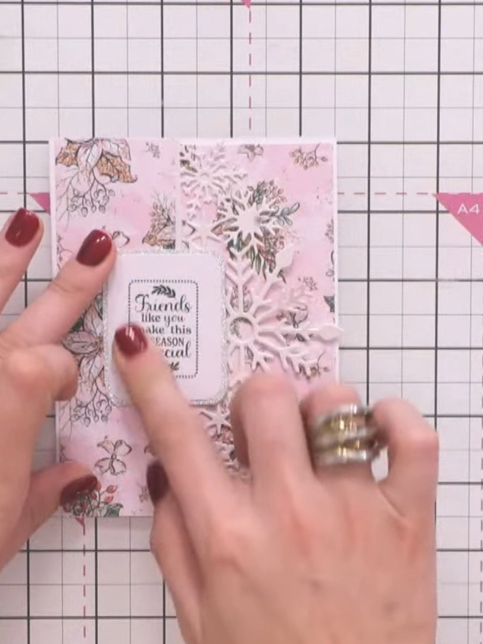 Step 8: Decorate the envelope flap with the same pink patterned paper and die-cut snowflakes to match your card design
