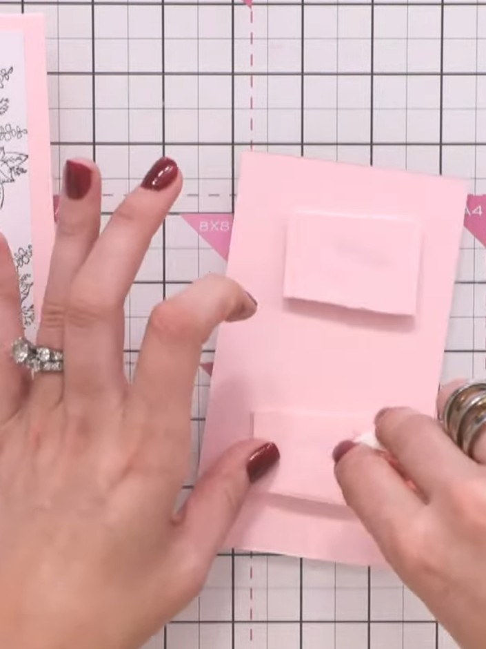 Step 11: Carefully line up the white stamped centre piece and secure it back into the pink frame, creating a spotlight 