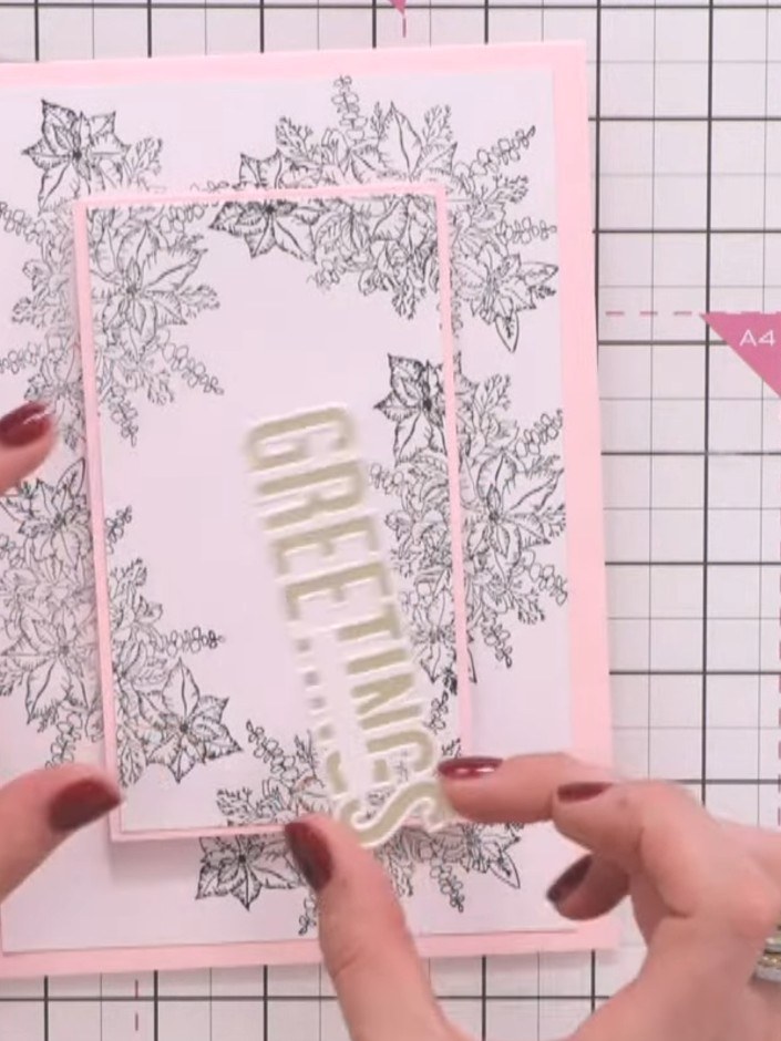 Step 12: Position and adhere a sentiment such as 'wishes' in gold foil to the centre of the card to complete your winte