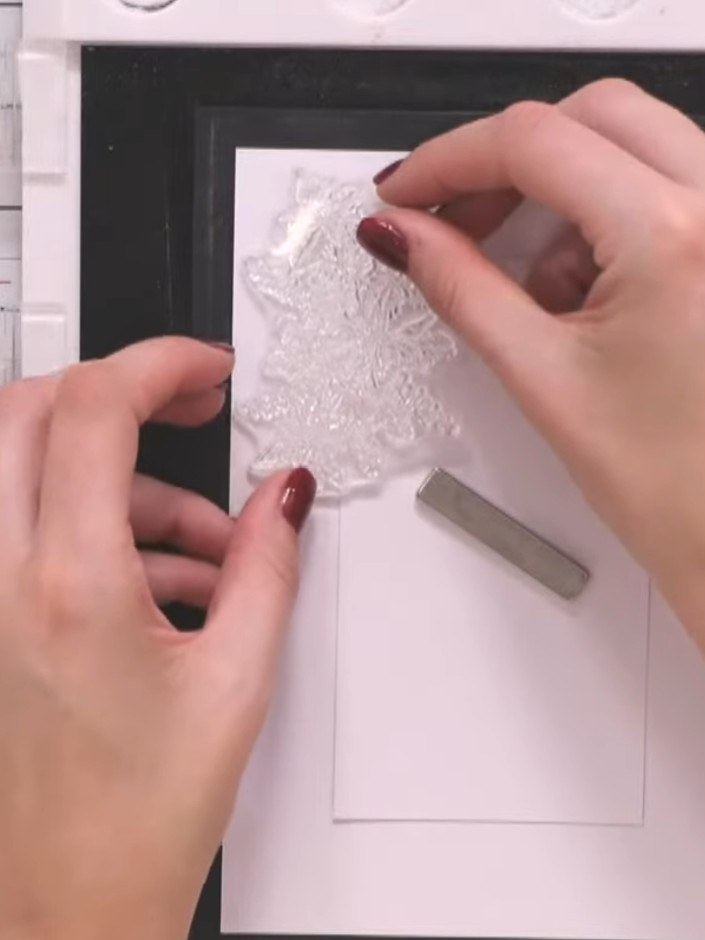 Step 5: Stamp the floral design repeatedly around the edges of the white centre panel to create a decorative border fr