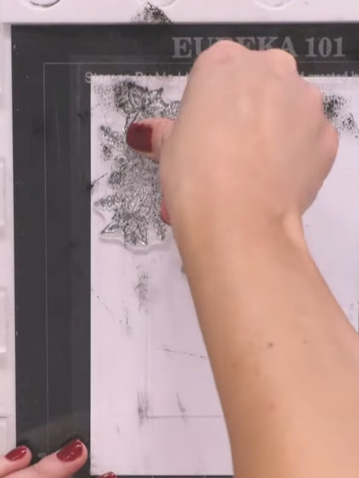 Step 6: Continue stamping the floral images around the entire frame aperture, varying the placement and allowing the s