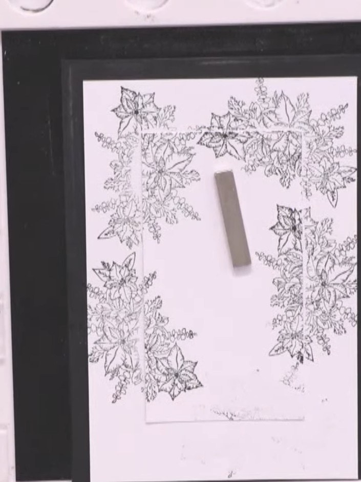 Step 8: Mount the stamped snowflake panel onto pink cardstock as a backing layer. Position the panel centrally and sec
