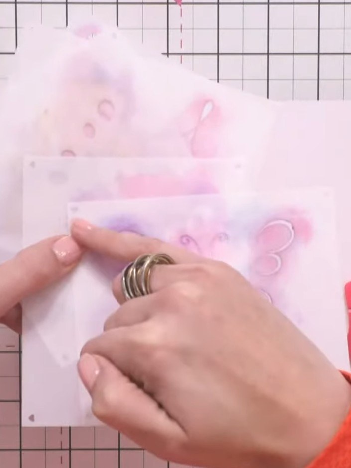 Step 1: Position the number one stencil in the corner of your white card base. Use the heart registration marks to ali