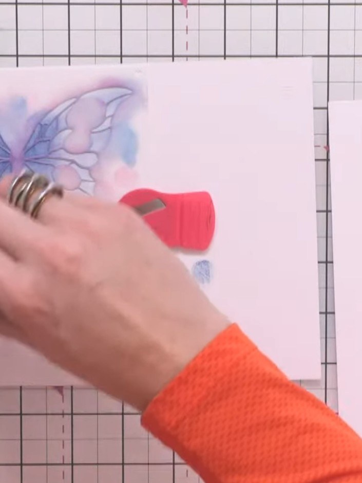 Step 3: Position stencil number two, aligning it in the corner. Apply pink ink through the stencil using a blending br
