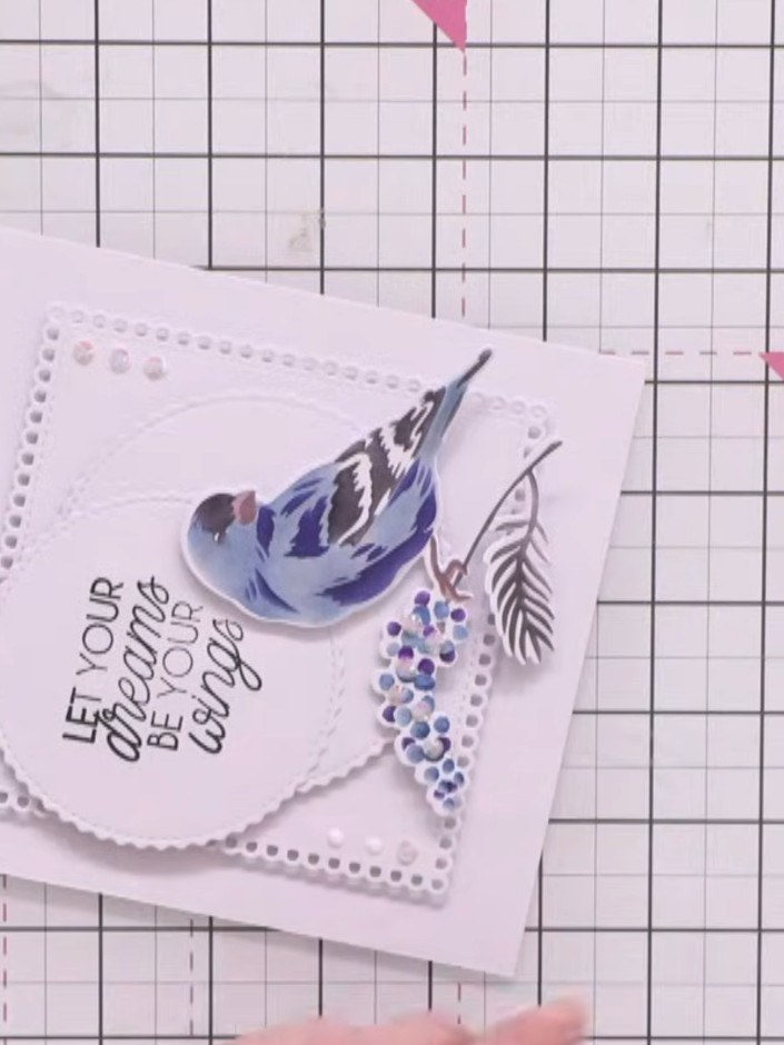 Step 12: Add small clear gems to the white space around the bird and in the corner areas to balance the design and add 
