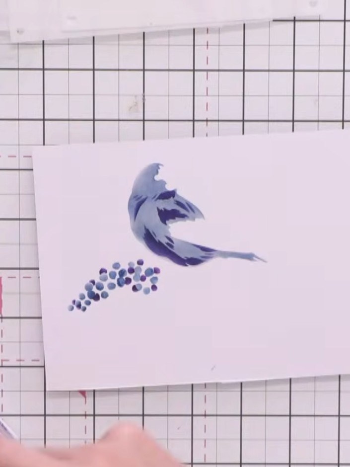Step 6: Position the third stencil over the stamped bird image. Using a light purple or lavender ink, lightly apply co
