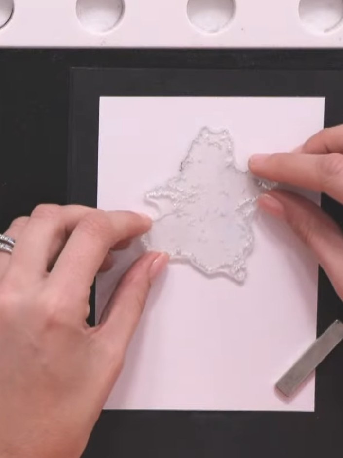 Step 2: Select the solid ship design from the lamination stamp set and place it onto your white cardstock on the black