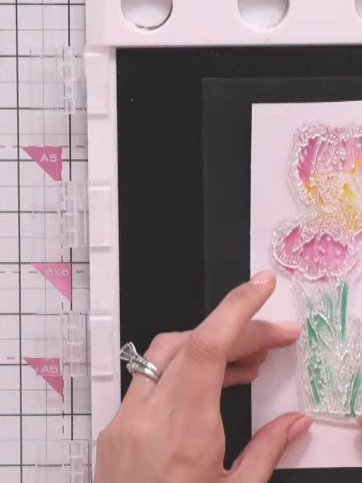 Step 10: Ink the outline stamp in black and carefully position it over your dried watercoloured background, aligning it
