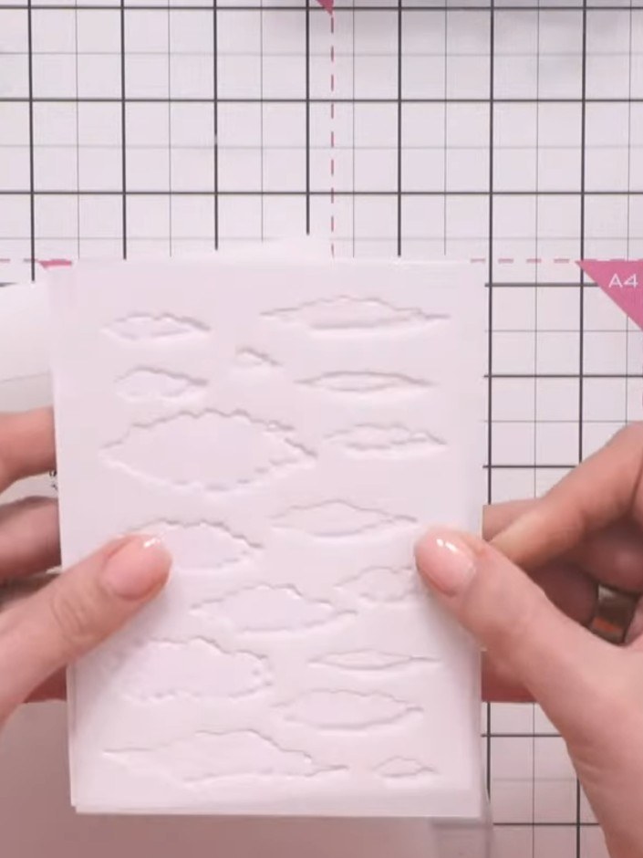 Step 4: Remove the card from the embossing folder and inspect the dimensional cloud details that have been created on 