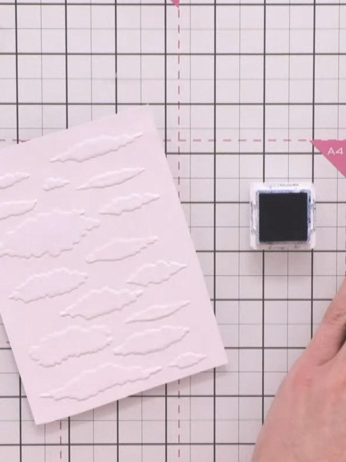 Step 6: Blend the ink over the embossed card using a blending tool or sponge. Work from the edges towards the centre t