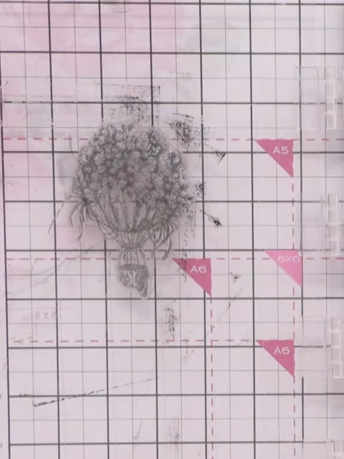 Step 3: Entinta el sello del globo aerostático con una almohadilla de tinta para embossing (tinta pegajosa). Ensure the stamp is evenly coated with the emb