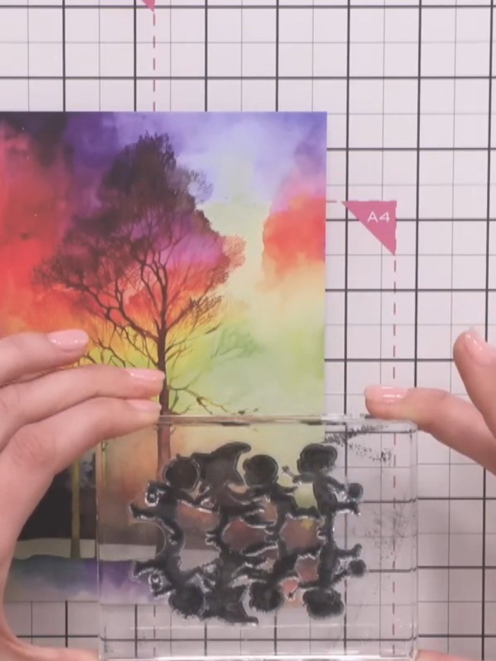 Step 3: Position the silhouette stamp at the base of your card and press firmly to stamp the children figures along th