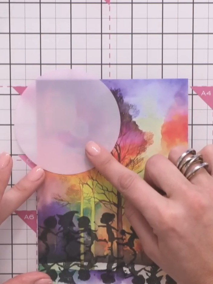 Step 5: Position the circular stencil mask on the upper portion of your card front where you want the moon to appear. 
