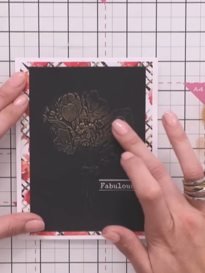Step 3: Lightly tap wax onto your finger and gently brush it onto the embossed detail on the black card panel. Use a l