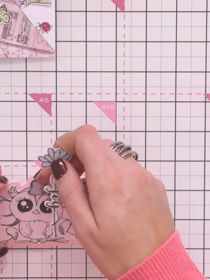 Step 9: Attach the floral word sentiment (such as 'Joy') to the back of a butterfly die-cut using tape, positioning it