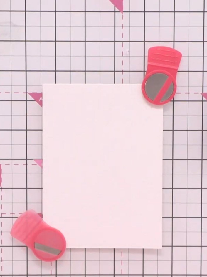 Step 1: Place a piece of white watercolour cardstock on your cutting mat. Secure it in position using magnets at the t
