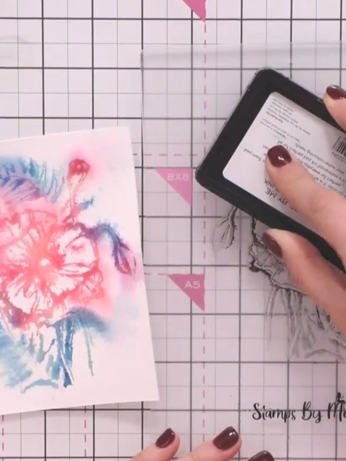 Step 10: Re-ink the stamp with black ink. Carefully stamp over the dried watercolour image to add detail and definition