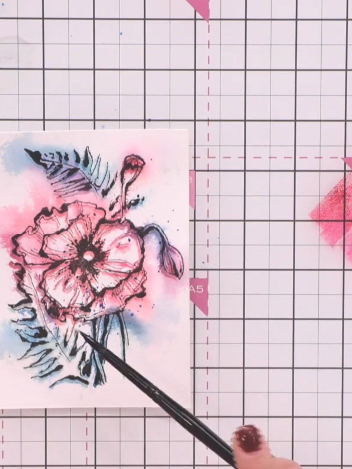 Step 11: Mix coloured inks with water on a palette. Flick a paintbrush loaded with the diluted ink over the card to cre