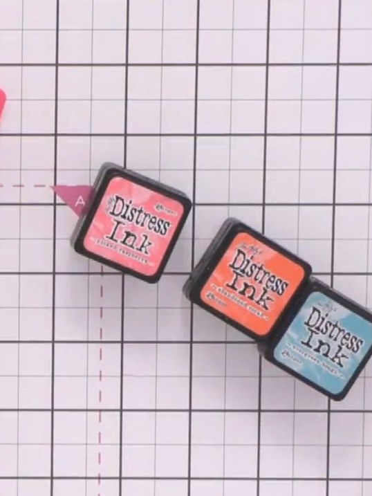 Step 2: Select three or more Distress Ink pads in complementary colours such as pink, coral/orange, and blue-green for