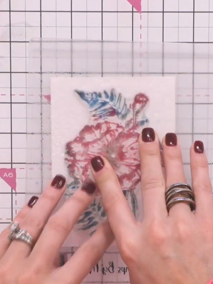 Step 7: Carefully lift the stamp away from the card to reveal the stamped poppy image with its beautiful watercolour e