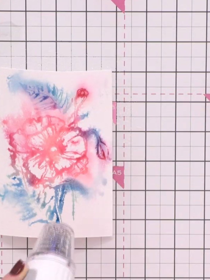 Step 9: Use a heat tool to dry the stamped and watercoloured floral image completely. Move the heat tool over the enti